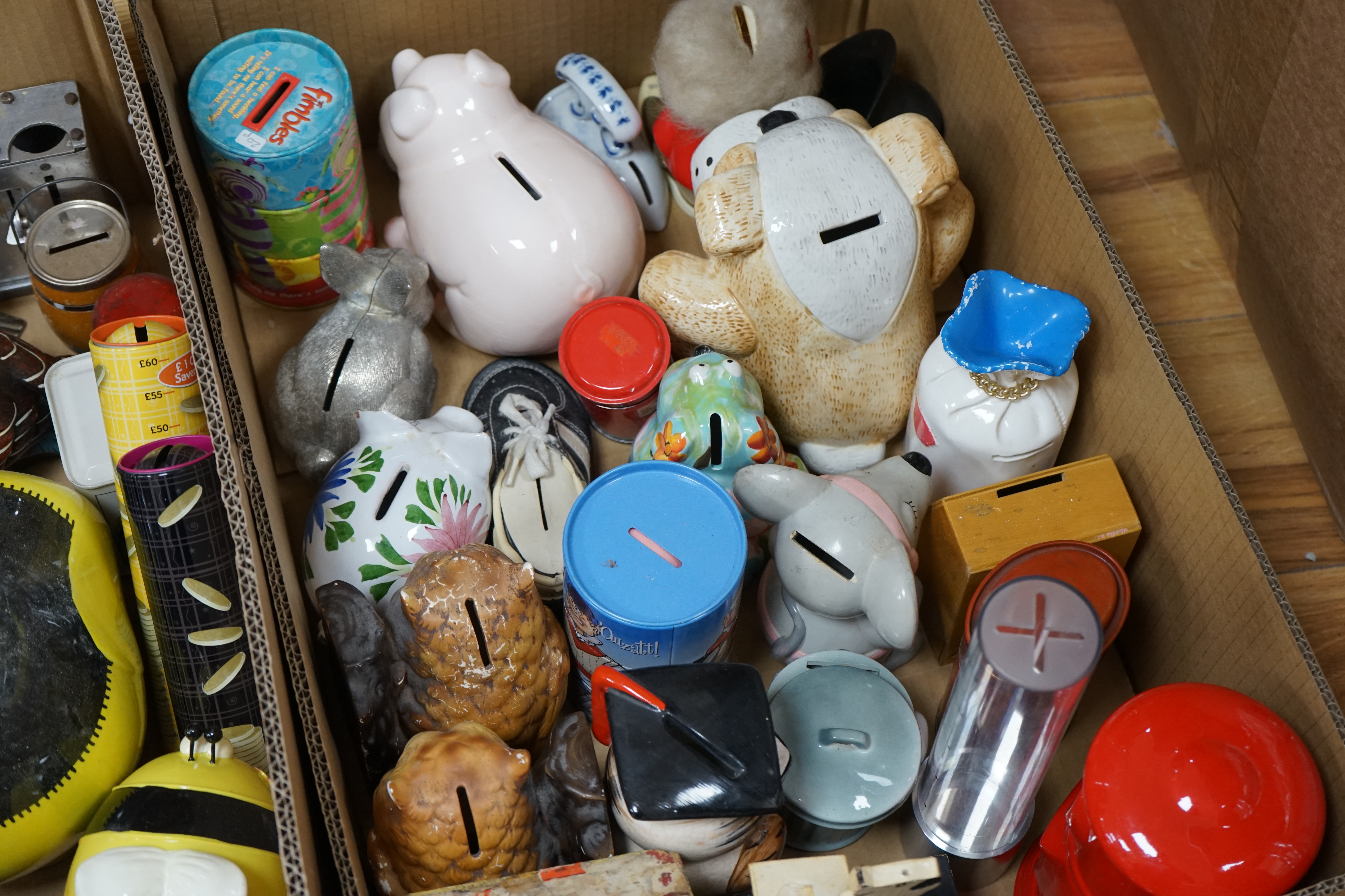 Three boxes of mixed novelty pottery, plastic and metal and wooden money boxes, largest 26cm high. Condition - variable
